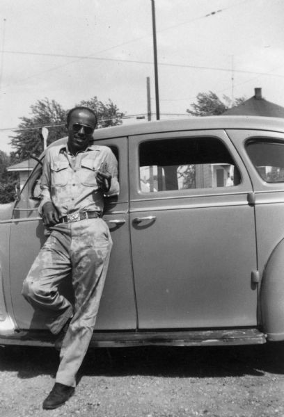 Lewis Arms leans against his 1941 Plymouth at Bernard Arms's home.
