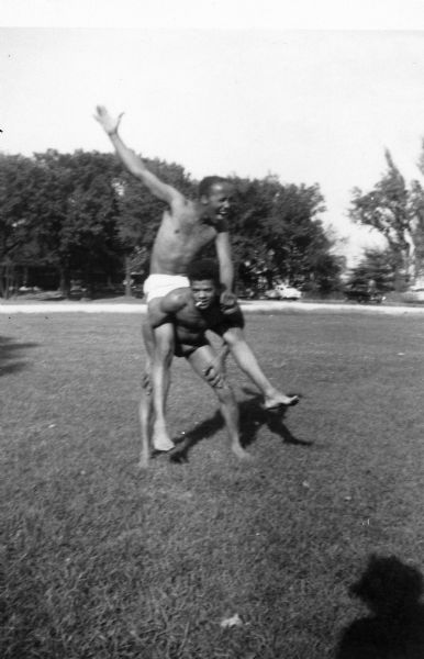 Lewis Arms sits on the back of his friend Curtis Taliaferro, goofing around at Brittingham Park Beach.