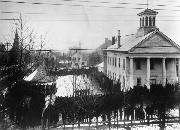 Elevated view. The church in the left background is the Zion Lutheran Church. The white house behind the bandstand is Captain Leahy's home (father of Admiral Leahy). Center, extreme background is the old Humbolt School, then a high school, now a junior high school. Immediately behind the Court House is the Washington School.