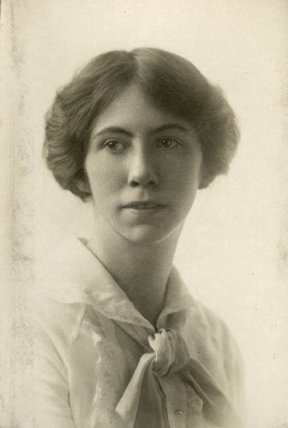 Quarter-length studio portrait of Miriam Bennett, wearing a scarf tie.