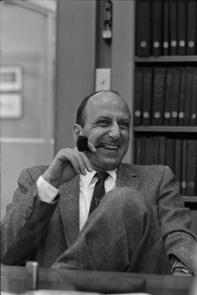 Portrait of Leslie H. Fishel, Jr., smiling broadly with his pipe at the State Historical Society of Wisconsin. He was the Director of the State Historical Society of Wisconsin from 1959 until 1969.