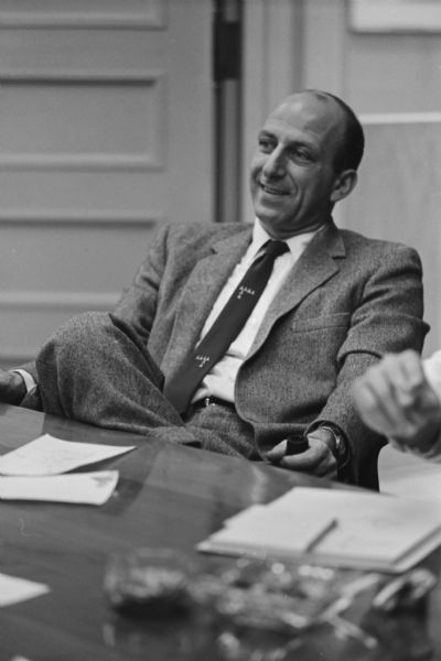 Portrait of Leslie H. Fishel, Jr., holding a pipe. He was the Director of the State Historical Society of Wisconsin from 1959 until 1969.