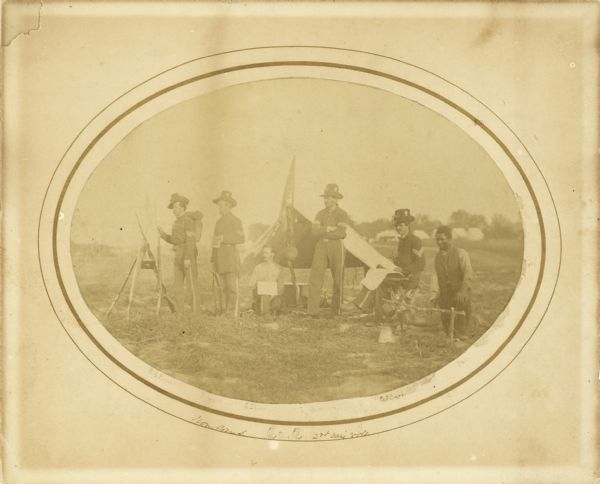 Non-commissioned officers of Company C of the 2nd Wisconsin. From left to right they are W.S. Rouse, R. Ash, G.E. Smith, N.H. Whittemore, O.F. Crary, and Josh, an African American. Four of the five soldiers are wearing the black hats of the Iron Brigade.