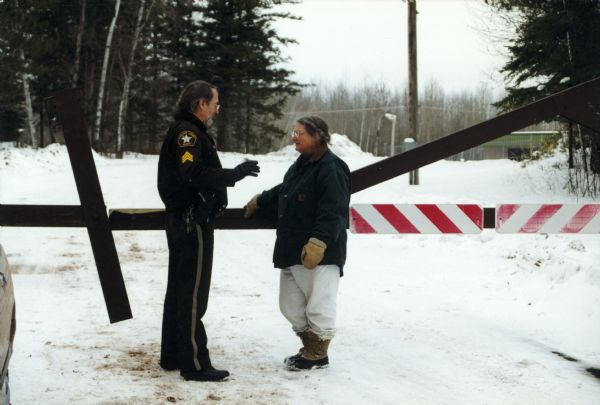 Bonnie Urfer, one of the leaders of Nukewatch, speaking with local police officer Ken Johnson outside the Project ELF facility. Nukewatch was present for one of its annual Martin Luther King Day demonstrations.