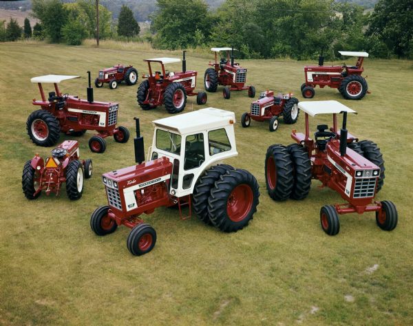 Color advertising photograph of the International family of tractors.