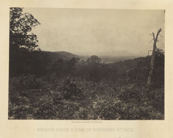 Location of Sherman's attack at Chattanooga. There is a road, trees and shrubs in the foreground, overlooking a valley. Mountains are in the distance.<br>Plate 12</br>