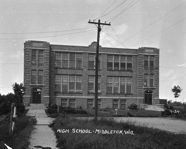 Exterior view of the Middleton High School. There is a telephone pole in front of the school.