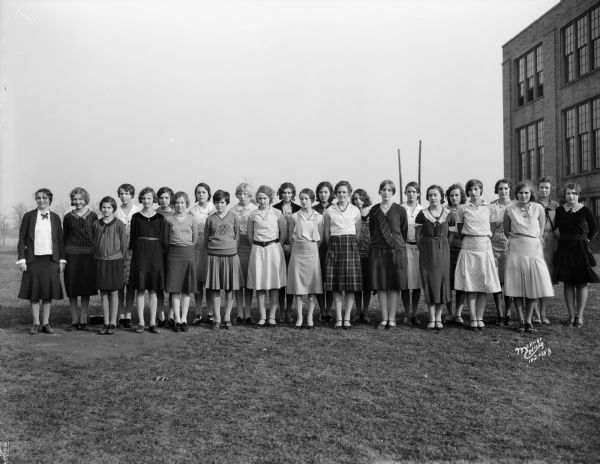 Group portrait of Middleton High School girls glee club taken outdoors.