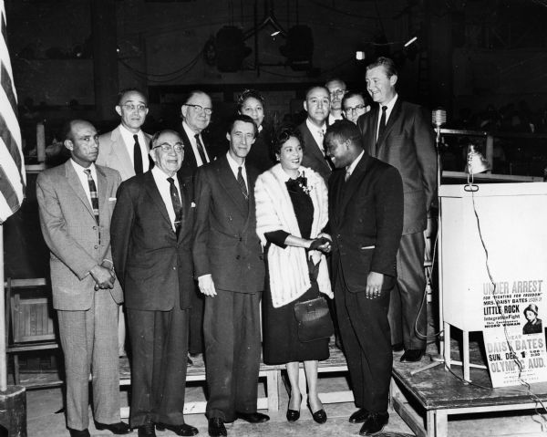 Daisy Bates, who is wearing a fur, poses with other people at an NAACP event.