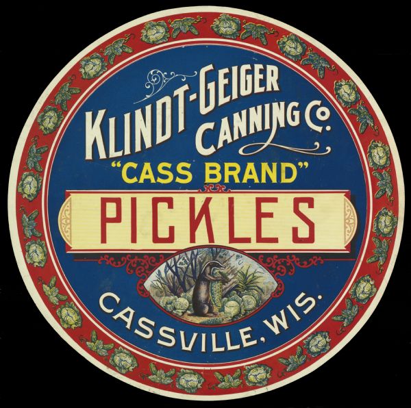 "Cass Brand" Pickles label featuring a badger holding a pickle in the middle of a cabbage patch. Klindt-Geiger Canning Co., located in Cassville, Wisconsin, operated from 1893 to 1950.