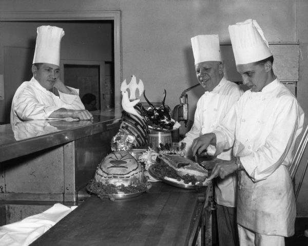 A student chef works in the kitchen of a Milwaukee restaurant with two older chefs as part of his training in a Restaurant and Hotel Cookery program at Milwaukee Vocational and Adult Schools.