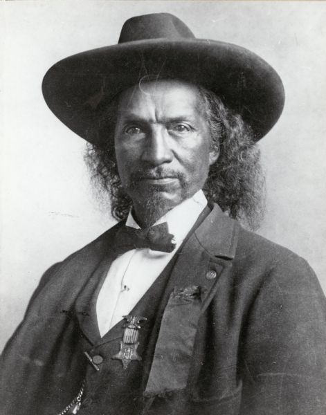 Quarter-length portrait of Stephen Nicholas (1840-1901) of Chilton, Wisconsin.  Stephen was a member of the Narragansett tribe.  He served with Co. D, 1st Wisconsin Cavalry during the Civil War.  He enlisted as a private, but later became a sergeant.  According to an 1886 article in the Neenah Gazette he was known for his "superhuman strength, undaunted courage, and excellent horsman[ship]."  In the photo Nicholas wears his GAR badge.