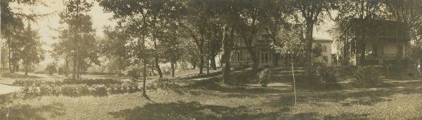 Panoramic view of the east lawn at Villa Louis. The house and office building can be seen at right.