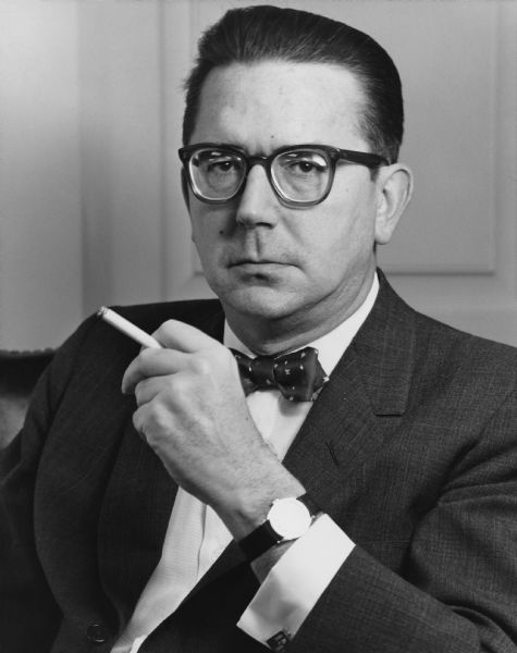 Quarter-length portrait of Rosser Reeves, holding a cigarette and wearing a bow tie.