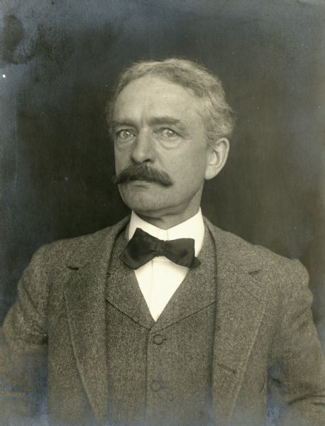 Quarter-length studio portrait of Edmund Burdick with moustache and gray hair.
