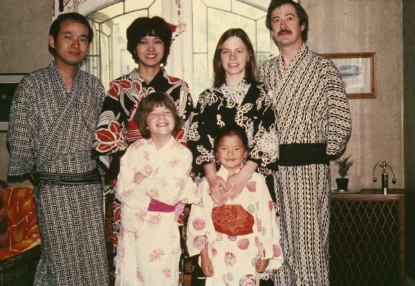 Adkins and Shindo families posing in yukatas (the garment) at the Adkins home. From left to right back row: Shizuo Shindo, MD, Mrs. Shindo, Loraine Adkins, William Adkins; front row: Koren "Sam" Adkins, Kati Adkins.

The Adkins family lived in Japan from August 1973 through August 1976 and moved to Madison when they returned to the United States.

The yukata worn by Loraine Adkins is in the Wisconsin Historical Museum collection (2011.16.2a-b).