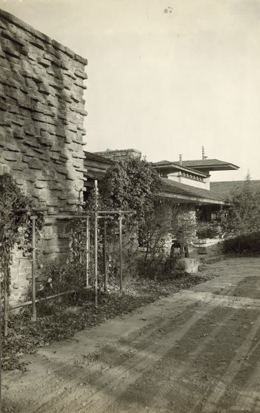 Exterior of the workroom chimney, the trellis and garden around the chimney, and the entry loggia of Taliesin II.
