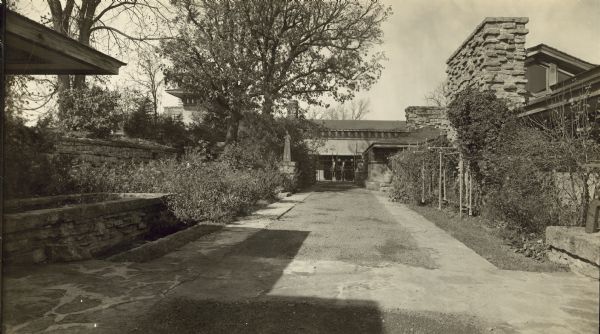 View of the west end of the courtyard in Taliesin II as seen from the residence. Two horses are in the background behind a gate.