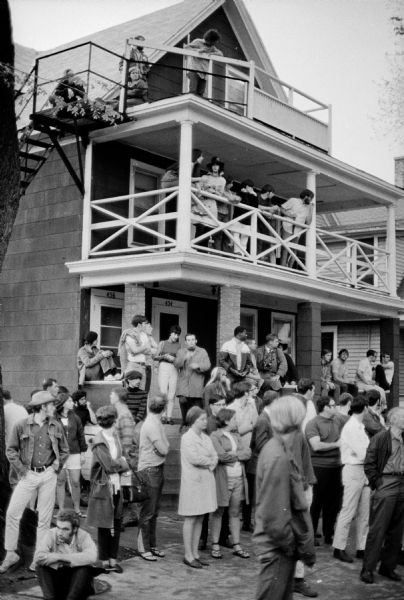 Crowd of people in front of house on Mifflin Street during the annual Mifflin Street block party.