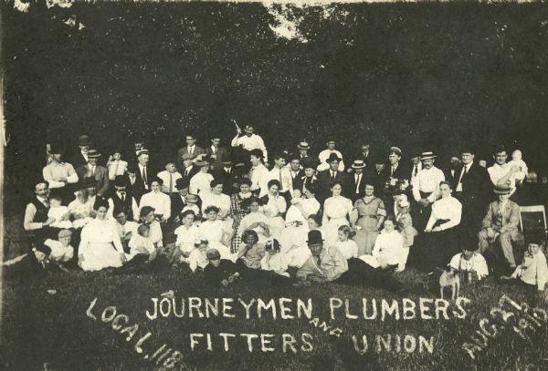 A group portrait of members and families of the United Association of Journeymen and Apprentices of the Plumbing and Pipefitting Industry, Local 118. The group was on an outing together.