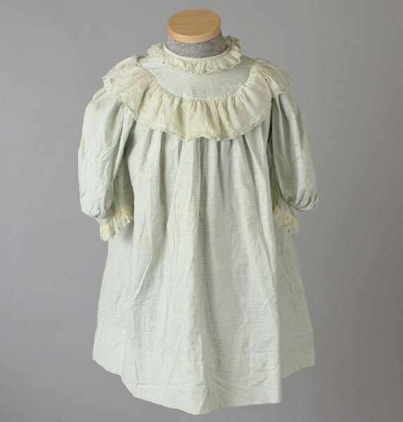 Front view of a boy's dress made of blue and off-white windowpane check cotton with off-white batiste trim. The dress was made 1900-1910.
