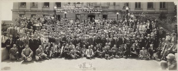 The Second Annual convention, referred to as "The Greatest Gathering of Magicians in the History of the World," of the International Brotherhood of Magicians held on June 8th, 9th, 10th, 1927 in Kenton, Ohio. The official photographer, Frank Barbeau of Oswego, N.Y., took the group picture. Ben Bergor is holding a "Madison, Wis" sign in the top left corner of the group.