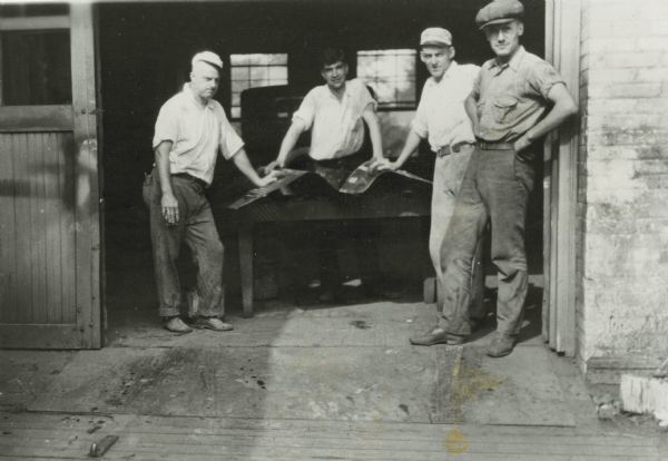 Four men, probably employees of the Ideal Body Company, standing in the doorway of the company's building on Park Street.