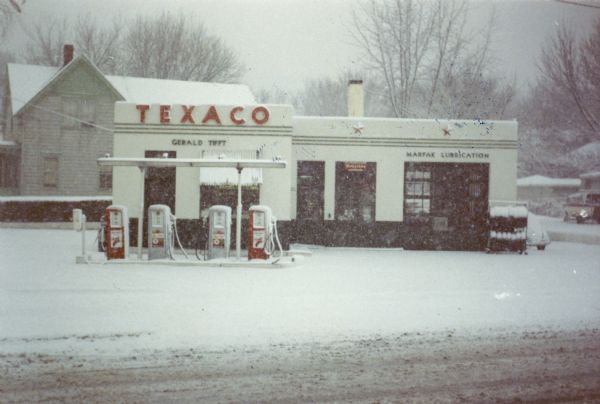 View from street of exterior of the Texaco Station located at 448 Park Street owned by Gerald Tifft. There is snow on the ground.