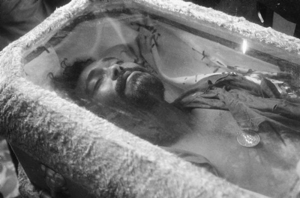 Dead soldier in a glass fronted coffin during the Cuban Revolution.
