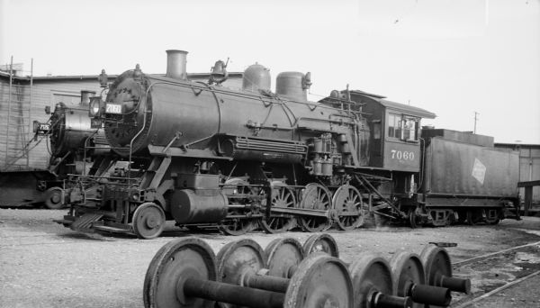 Left side view of locomotive engine no. 7060, a steam locomotive of the Chicago, Milwaukee, St. Paul and Pacific Railroad Company.