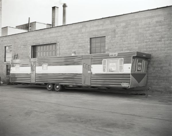 Rollohome mobile home as received from the factory and parked at Reynolds Transfer and Storage Co. on E. Main Street prior to being moved to the State Historical Society building for conversion into the Historymobile, the Society's mobile museum which traveled throughout the state with exhibits on Wisconsin history.