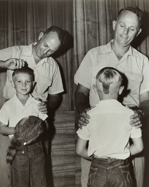 Composite photograph of a boy and his barber. The front view shows the boy holding a coonskin cap popularized at the time by the Davy Crockett television program. The back view shows that the boy's hair is cut into a shape resembling the coonskin cap.