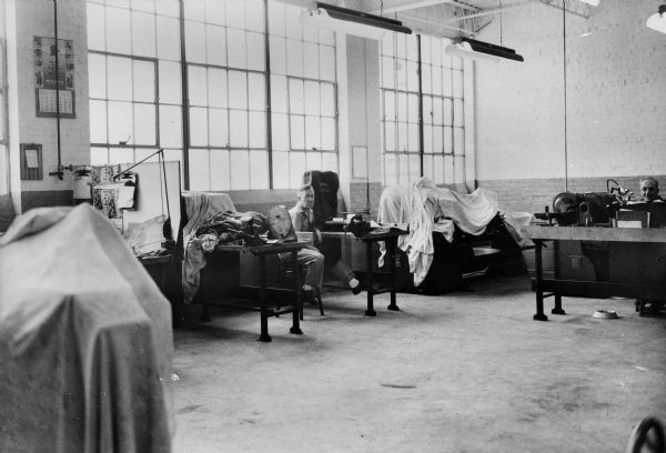 Men working in the tool room, located in the northeast corner of Building #15.