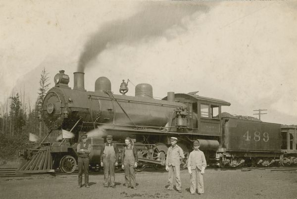 Chicago, Milwaukee, & St. Paul Railway engine no. 489. Five railroad employees stand in front of the locomotive.