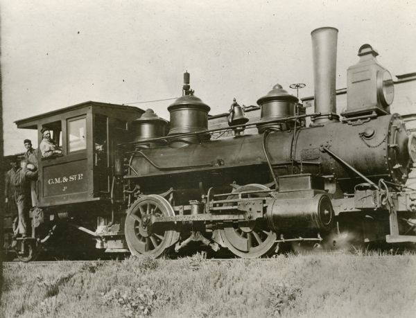 Chicago, Milwaukee, & St. Paul Railway engine no. 1079, class J2. The engineer was Philip Currie and the fireman was Edward C. McNeill. The third man in the photograph is unidentified.