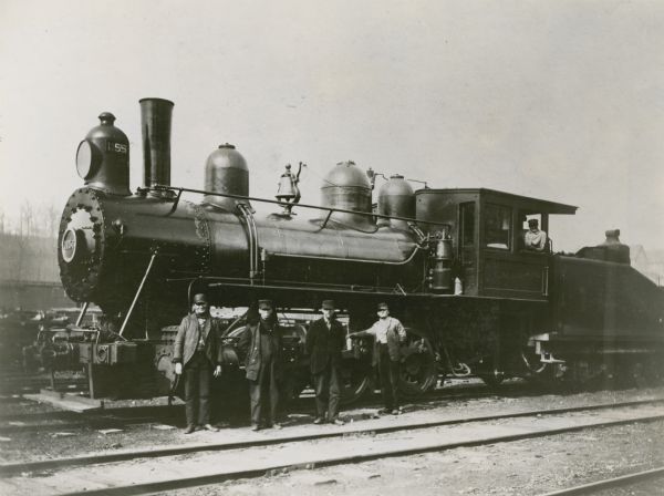 Chicago, Milwaukee, & St. Paul Railway engine no. 1155, class I4, built by the company's shop in 1901. Posing in front of the engine from left to right, are: switchman M.J. "Dad" Kane (Kaine?), switchman August Rudolph, switchman James Hanson, fireman George Patterson, and engineer John McCauley.