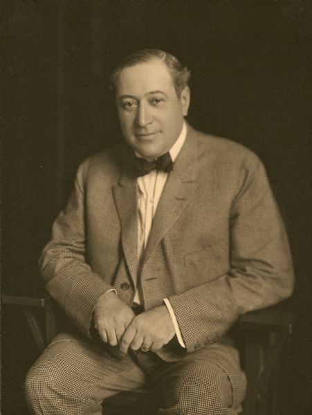 Portrait of Henry Harris, seated, wearing a bow tie and suit.