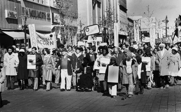 A crowd of people with signs march to the Democratic Party mid-term convention during the first national ACORN convention.