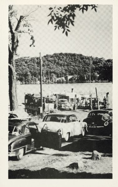 Automobiles line up to wait for the Merrimac ferry "Colsac".