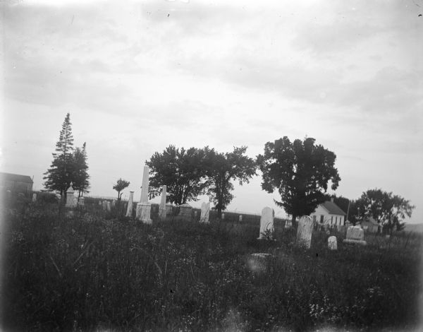 Graveyard with buildings in the background.