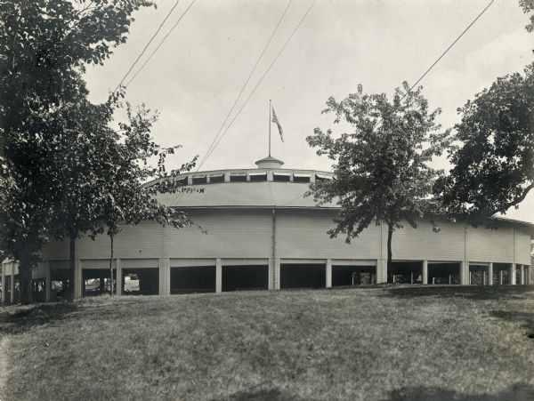 Monona Lake Assembly Auditorium and grounds. Designed by Morrison H. Vail of Chicago, built in 1900 by John H. Starck Co., John H. Findorff, vice-president. There is an American flag flying from the top of the auditorium.  Torn down in 1943.