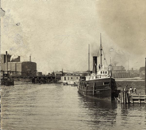 The "J.C. Ames," a Lake Michigan car ferry, probably in the South Chicago harbor. There is a railroad bridge visible in the background.