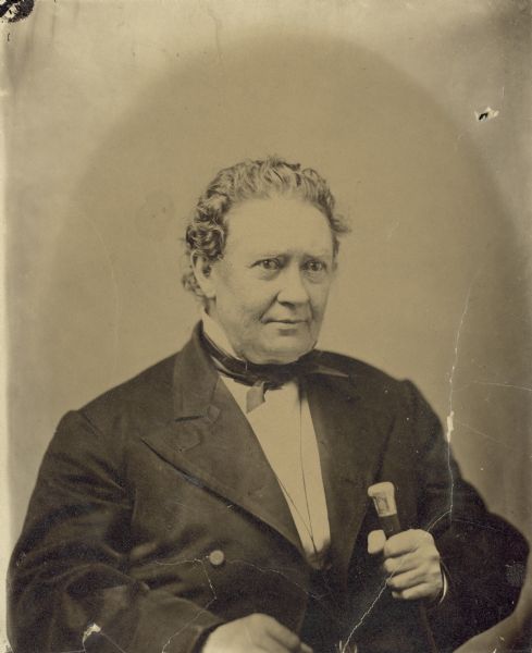 Waist-up studio portrait of Edward George Ryan holding a cane.