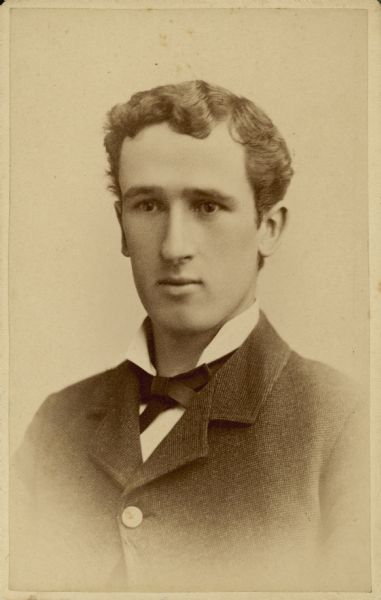 Head and shoulders studio portrait of Edward A. Bass wearing a shirt with winged collar and a necktie.