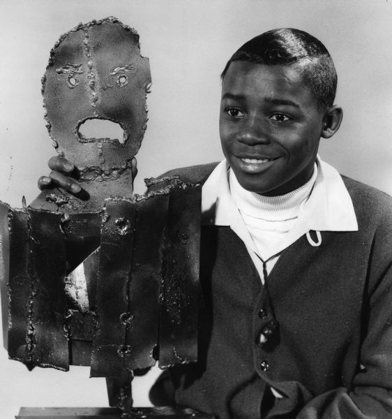 Thurman Butler, 16, with the sculpture he made while practicing cutting and welding techniques in a foundry course at Milwaukee Technical college. He called the sculpture <i>Boy in Poverty</i>.