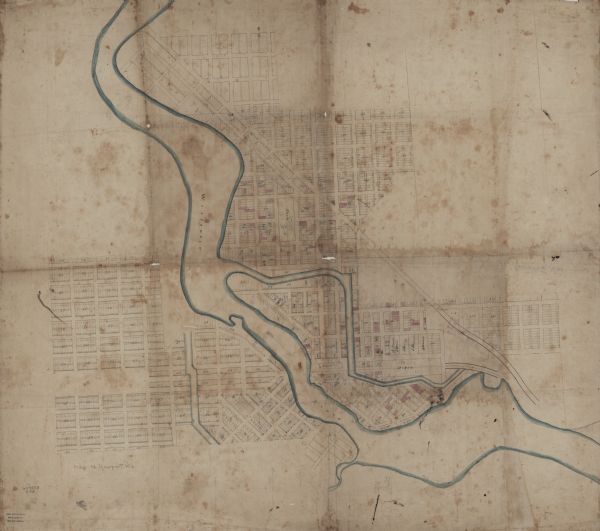 This map is ink and watercolor on tracing cloth and shows lot and block numbers, streets, a park, and depots. Some lots are colored red or blue and some include annotations.