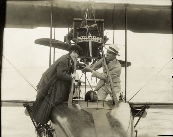 Luise D'Auvergne (Marguerite Courtot) and Jean-Marie (Owen Moore) board a seaplane in a production still from the Famous Players film "The Kiss."