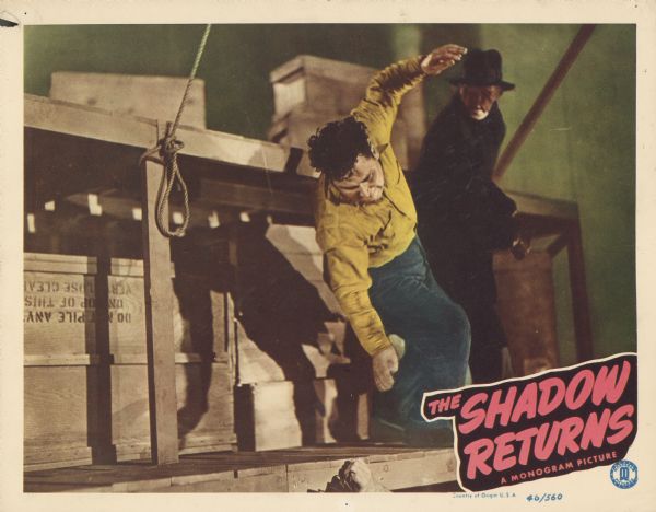 Lobby card for the Monogram film "The Shadow Returns," featuring a colorized still of The Shadow punching a criminal.