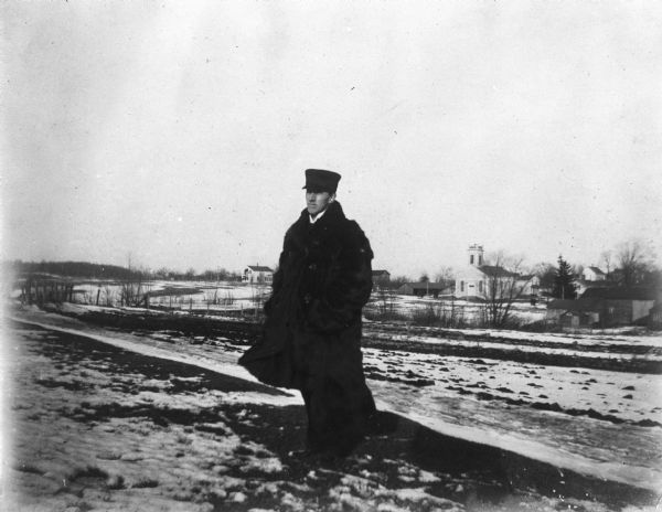 Albert Knowles, brother-in-law of William Wade, at Herrling Farm. The Greenbush Baptist Church is visible in the background.