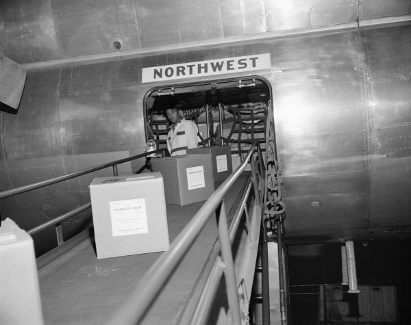 Polio vaccine being unloaded (?) from a Northwest airplane.